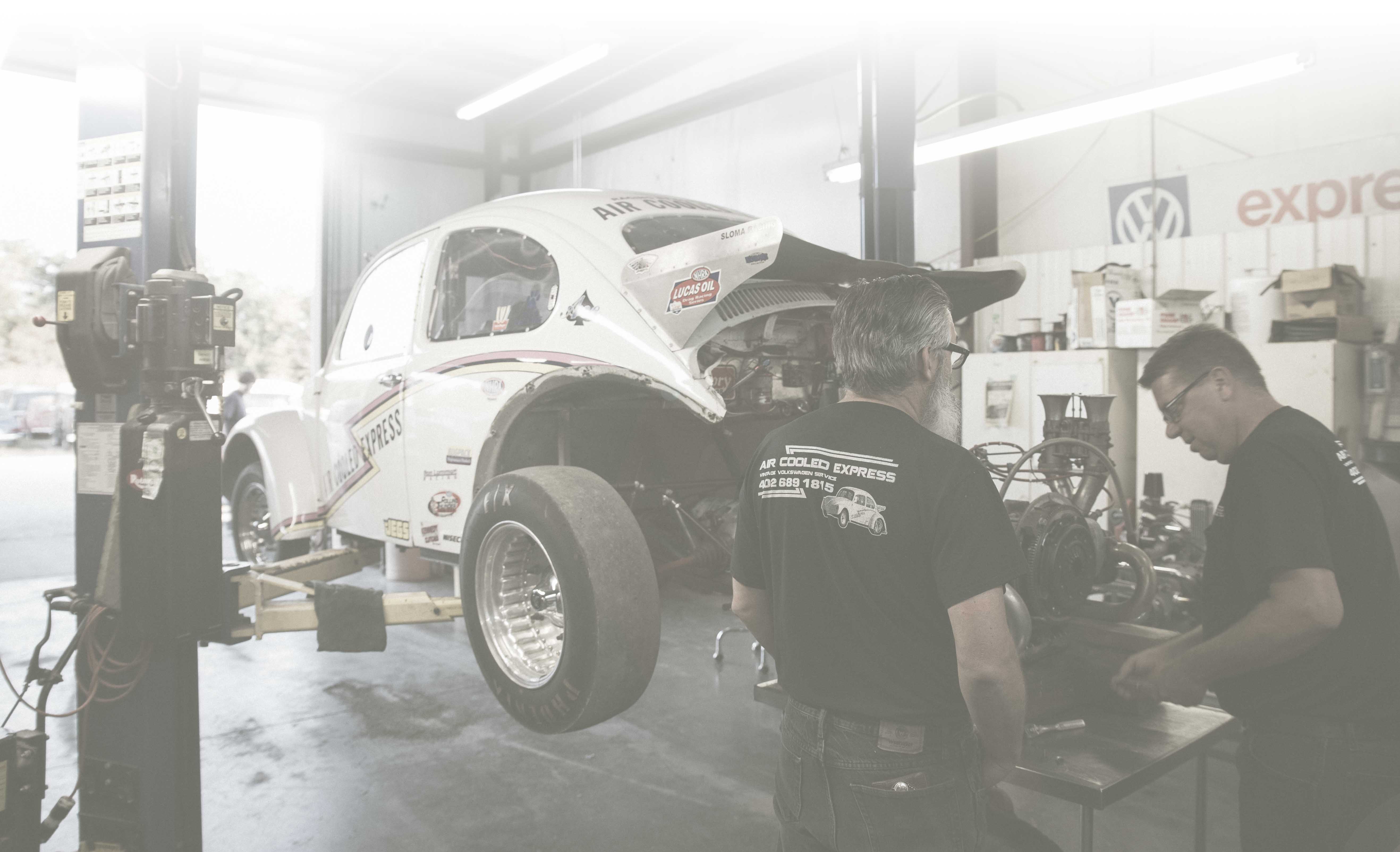 Home page image Mike Carroll and Danny Kaven working on the race car.